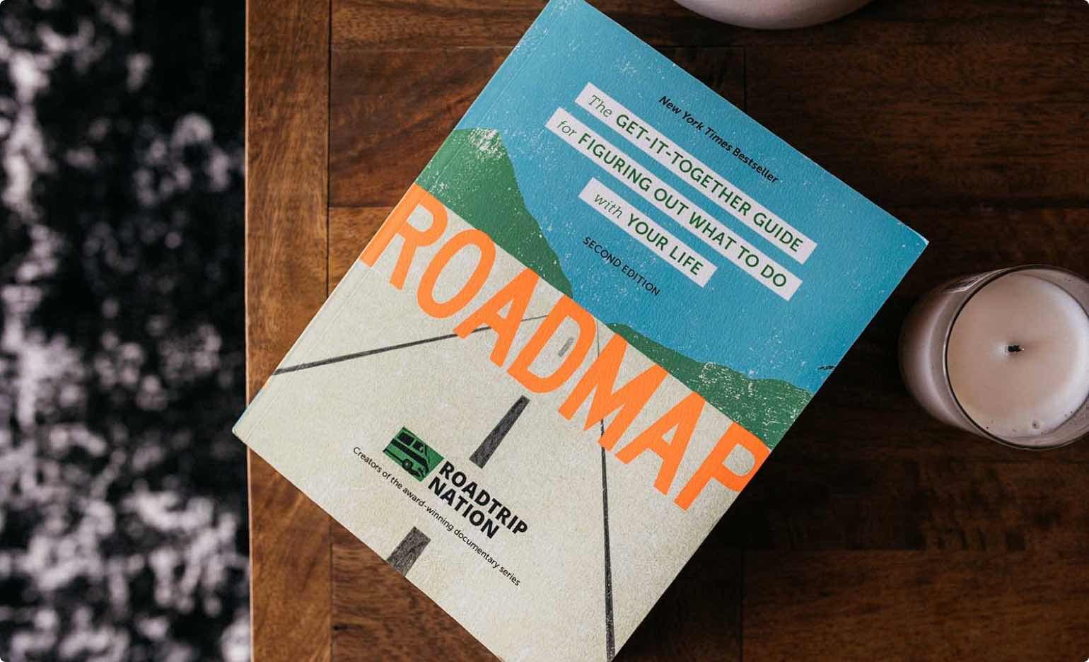 Roadmap book on a table with candles